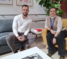 Kaksi henkilöä istuu sohvalla ja nojatuolissa.