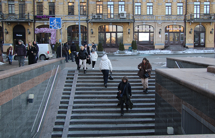 Rappuset, jotka johtavat alikulkutunneliin. Ihmisiä kävelemässä rappusissa.